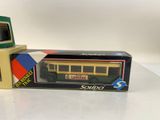 two boxed boxed toys of a yellow and green train car