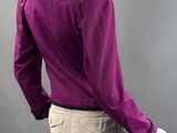 an image of a mannequin mannequine wearing a purple shirt and beige pants