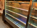 a glass display case in the middle of a store