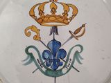 a plate with a crown on it and a sword on it