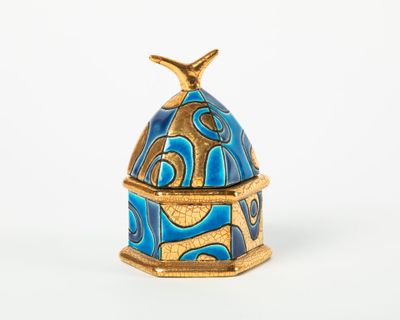 an image of a blue and gold box with a bird on top of it