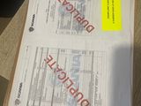 two documents on a table with a yellow sticker that says duplicate