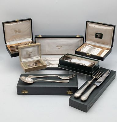 several silverware items including a spoon, fork and spoon rest