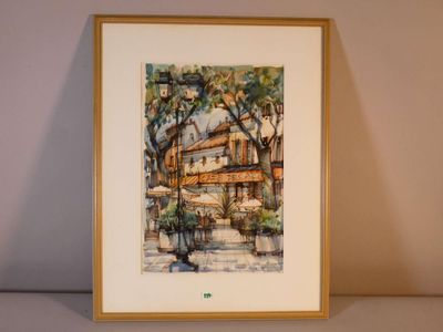 framed watercolor painting of a street scene with a cafe in the background