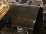a silver dishwasher sitting on top of a counter in a kitchen