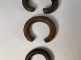 three pieces of wood sit on top of a white surface