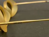 pair of gold rimmed glasses on a black surface with a pair of gold rimmed glasses on a black surface with a pair of gold rimmed glasses
