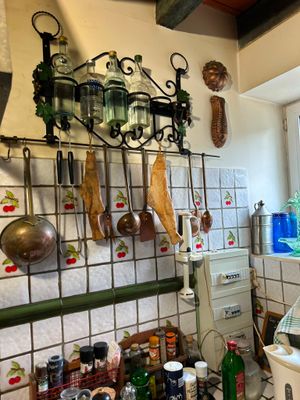 a picture of a kitchen with a lot of clutter on the wall