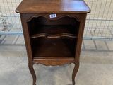 a wooden table with a shelf on top of it