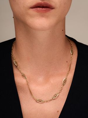 a woman wearing a black shirt and a gold chain necklace