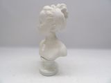 a white busturine of a woman on a white table
