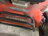 a lawn mower that is sitting on the ground