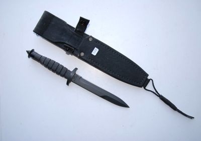 a knife and a sheath on a white surface