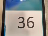 a tablet with a number on it sitting on a table