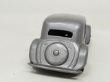 a silver toy car that is sitting on a table