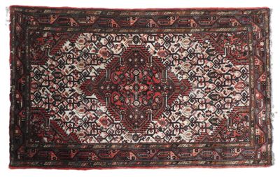 un tapis persan ancien aux motifs rouges et noirs