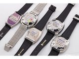 several different types of watches are lined up on a white surface