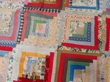 a close up of a patchwork quilt on a bed