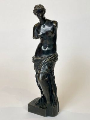 an image of a statue of a woman on a marble base