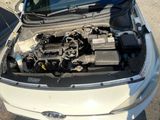 a white car with the hood open and the engine in the trunk