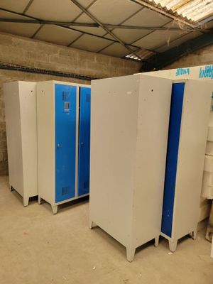three blue and white lockers in a room