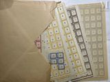 several pieces of brown paper with blue and yellow squares on them