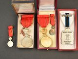 three medals and a medal in a red box on a table
