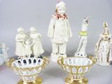 five figurines of people in different styles and sizes