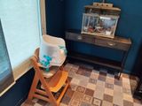 a baby highchair in the corner of a room