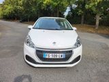 a small white car parked on the side of the road