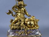 a gold statue of a woman sitting on a marble base