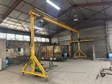 a large yellow crane sitting inside of a warehouse next to a building