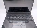 a laptop that is open on a white surface