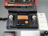 a box with a remote and a controller on the table