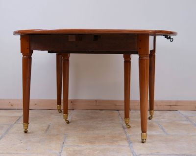 a small table with a drawer on it on a tile floor