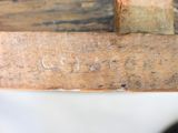 a close up of a piece of wood with a hammer on it