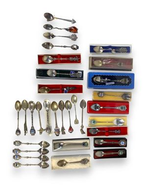 a lot of spoons and spoon knives on the table
