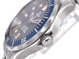 a close up of a watch with a blue face