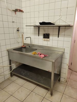 a kitchen with a sink and a counter in it