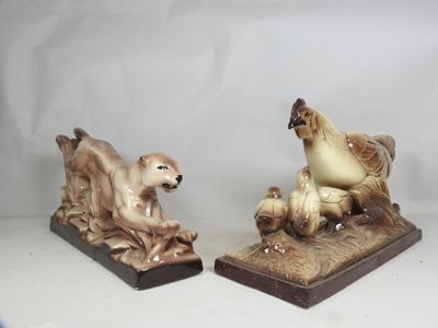 pair of ceramic figurines of a dog and a chicken