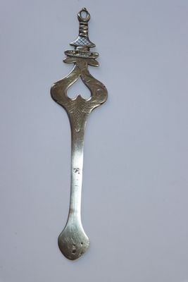 une vieille cuillère en argent surmontée d'un oiseau