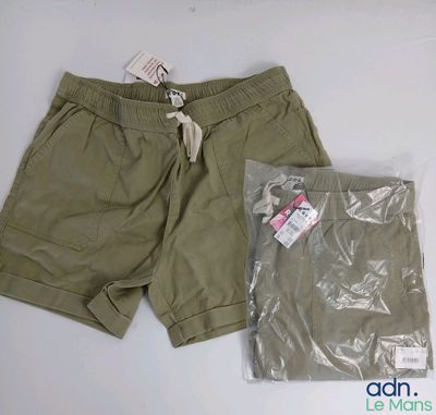 Le short est vert et comporte une étiquette blanche.