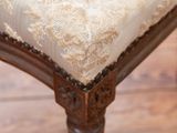 a close up view of a chair with a white upholstered seat