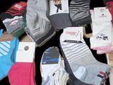 many pairs of socks that are sitting on a table