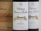 two bottles of wine sitting next to each other on a table