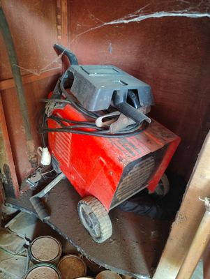 a red machine that is sitting in the corner of a room