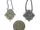 three pieces of metal with turquoise and brown designs on them