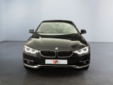 bmw 4 series saloone in a showroom with a black background