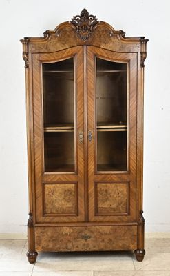 an antique wooden display cabinet with glass doors and shelves