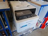 a printer that is sitting on a shelf in a room